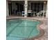 Kidney shaped pool with brick coping and patio furniture at 766 Bryson Loop, Lakeland, FL 33809