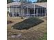 Screened-in pool area with lounge chairs and landscaping at 766 Bryson Loop, Lakeland, FL 33809