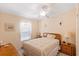 Guest bedroom with wood furniture and ceiling fan at 108 Dogwood Trl, Leesburg, FL 34748