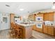 Modern kitchen with white appliances and wood cabinetry at 108 Dogwood Trl, Leesburg, FL 34748