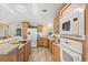 Kitchen with white appliances and light wood cabinets at 108 Dogwood Trl, Leesburg, FL 34748