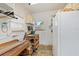 Workshop with workbench, storage, and window for natural light at 108 Dogwood Trl, Leesburg, FL 34748