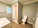 Bathroom featuring shower with shower curtain, toilet and vanity with sink at 100 Papaya Cv, Leesburg, FL 34748