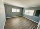 Empty bedroom with two windows and wood flooring at 100 Papaya Cv, Leesburg, FL 34748