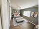 Bright bedroom featuring neutral walls, light hardwood floors, ceiling fan, and natural light from the window at 100 Papaya Cv, Leesburg, FL 34748
