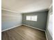 Bedroom with window and grey walls with white trim at 100 Papaya Cv, Leesburg, FL 34748