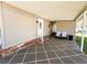 Inviting covered parking area with tiled flooring and space for seating and outdoor enjoyment at 100 Papaya Cv, Leesburg, FL 34748