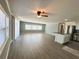 Spacious living area connected to a kitchen featuring an island and stainless steel appliances at 100 Papaya Cv, Leesburg, FL 34748