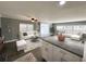 Open-concept living room featuring hardwood floors and abundant natural light at 100 Papaya Cv, Leesburg, FL 34748