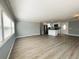 Large living space flowing into a modern kitchen, perfect for entertaining guests at 100 Papaya Cv, Leesburg, FL 34748
