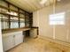 Unfinished storage area with ample shelving and cabinetry at 100 Papaya Cv, Leesburg, FL 34748