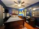 Comfortable bedroom with wood floors and dark blue walls at 1315 Red Colt Ct, Astor, FL 32102