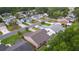 Aerial view of homes in a tranquil neighborhood setting, featuring landscaped yards and proximity to community amenities at 1411 Juarez Pl, The Villages, FL 32159