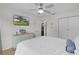 Bright bedroom featuring a ceiling fan, dresser and TV, complemented by a spacious closet for ample storage at 1411 Juarez Pl, The Villages, FL 32159