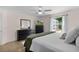 Bright bedroom with neutral walls, ceiling fan, and large window providing natural light and outdoor views at 1411 Juarez Pl, The Villages, FL 32159