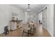 Bright dining area features stylish table setting, natural light, and a modern design at 1411 Juarez Pl, The Villages, FL 32159