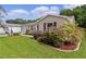 Well-maintained exterior with lush landscaping and manicured lawn on a sunny day at 1411 Juarez Pl, The Villages, FL 32159