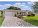Charming home exterior with well-kept lawn, paved driveway, and lovely landscaping at 1411 Juarez Pl, The Villages, FL 32159