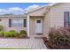 Charming front entrance with a welcoming doorway, neatly manicured shrubs, and walkway at 1411 Juarez Pl, The Villages, FL 32159