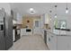 Bright kitchen featuring white cabinetry, stainless steel appliances, and granite countertops at 1411 Juarez Pl, The Villages, FL 32159