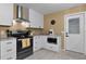Well-lit kitchen with white cabinets, stainless steel appliances, and tile flooring at 1411 Juarez Pl, The Villages, FL 32159
