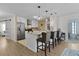 Modern kitchen featuring stainless steel appliances, white cabinets, and a kitchen island with barstool seating at 1411 Juarez Pl, The Villages, FL 32159