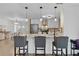 Kitchen island featuring seating, pendant lighting, and stainless appliances, adjacent to dining area at 1411 Juarez Pl, The Villages, FL 32159