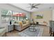 Cozy living room with many windows, comfortable seating, and a view of the outdoors at 1411 Juarez Pl, The Villages, FL 32159
