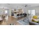 Open living space with kitchen island, dining area, and comfortable seating at 1411 Juarez Pl, The Villages, FL 32159