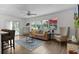 Comfortable living room with large windows, plush seating, and access to outdoor space at 1411 Juarez Pl, The Villages, FL 32159