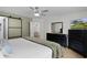 Spacious main bedroom featuring a sliding barn door to bathroom and ceiling fan at 1411 Juarez Pl, The Villages, FL 32159