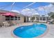 Screened-in pool area with in-ground pool and patio furniture at 1411 Juarez Pl, The Villages, FL 32159