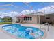 A refreshing in-ground pool with screen enclosure, patio area, and inflatable toys at 1411 Juarez Pl, The Villages, FL 32159