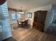 Dining Room featuring wood laminate floors, dining table with 4 chairs, and decorative cabinet at 1618 Juno Trail, Astor, FL 32102
