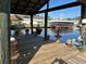 Picturesque view of the channel from the waterfront covered dock with adjacent potted plants at 1618 Juno Trail, Astor, FL 32102