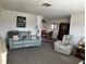 Comfortable living area featuring plush sofa, recliner, and view into dining area at 1618 Juno Trail, Astor, FL 32102