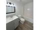 Clean bathroom featuring a gray vanity and bathtub at 203 Juniper Way, Ocala, FL 34480