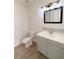 Clean bathroom with gray vanity and a modern light fixture at 203 Juniper Way, Ocala, FL 34480