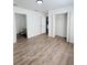 Simple bedroom with wood-look floors and a large closet at 203 Juniper Way, Ocala, FL 34480