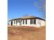 White house with black shutters, newly landscaped and freshly painted at 203 Juniper Way, Ocala, FL 34480