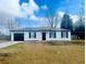 Newly constructed home with white siding, black accents, and a landscaped yard at 203 Juniper Way, Ocala, FL 34480