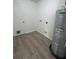 Laundry room with vinyl flooring and water heater at 203 Juniper Way, Ocala, FL 34480