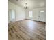 Spacious living room with hardwood floors and chandelier at 203 Juniper Way, Ocala, FL 34480