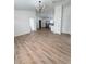 Open concept living room and kitchen with hardwood floors at 203 Juniper Way, Ocala, FL 34480
