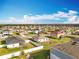 Wide aerial view of a residential community with well-maintained lawns and tidy streets at 2369 Crossandra St, Mascotte, FL 34753