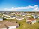 Large residential area with manicured lawns, modern homes, and well-maintained streets at 2369 Crossandra St, Mascotte, FL 34753