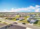 Overview of a residential neighborhood featuring tidy lawns and modern homes at 2369 Crossandra St, Mascotte, FL 34753
