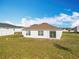 Spacious backyard featuring lush green grass and a well-maintained white home exterior at 2369 Crossandra St, Mascotte, FL 34753