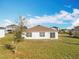 Well-kept backyard with healthy grass and a view of neighboring houses at 2369 Crossandra St, Mascotte, FL 34753