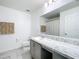 Bathroom featuring a marble countertop vanity and modern fixtures at 2369 Crossandra St, Mascotte, FL 34753